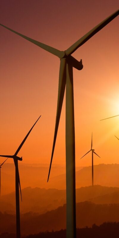 Wind turbine farm power generator in beautiful nature landscape for production of renewable green energy is friendly industry to environment. Concept of sustainable development technology.